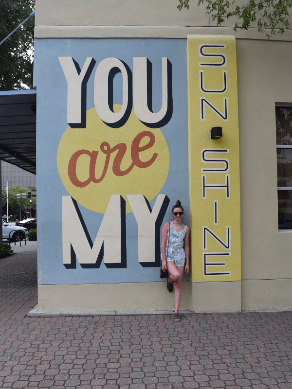 Posing in front of a mural in St. Petersburg, Florida